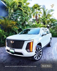A sleek white luxury SUV is parked on a cobblestone driveway, surrounded by lush green tropical plants, exuding elegance and sophistication. The button reads “Book Now.”